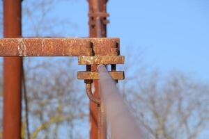 Fastening clamp on the steel cable of the bridge photo