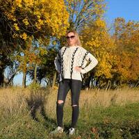 Girl in sunglasses. Girl on a background of yellow leaves of autumn trees. Autumn photo session.