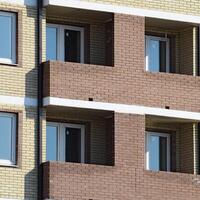 Balconies and windows of a multi-storey new house photo