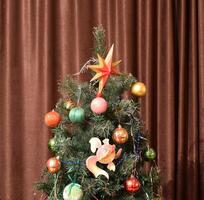 Christmas toys and ornaments on the Christmas tree photo