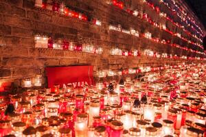 Candlelit Memorial Exhibit Featuring the Latvian Flag and Its Colors photo