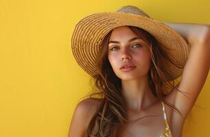 AI generated woman posing on a yellow background in a straw hat. photo