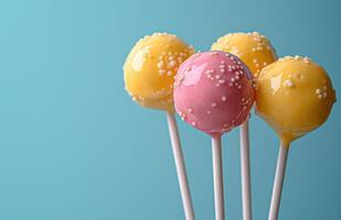 AI generated easter lollipops in pastel pink and yellow that is on a blue background photo