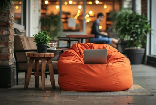 AI generated an orange bean bag chairs man with a smart phone and laptop on it photo