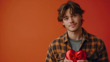 ai generado joven hermoso chico participación un rojo en forma de corazon caja con un arco en su mano foto