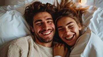 AI generated A happy couple in matching pajamas laughs while lying in bed photo