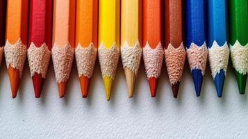 AI generated Colored pencils lie in a row on a bright minimalistic background photo