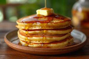 AI generated A fluffy stack of pancakes drizzled with maple syrup, topped with a pat of melting butter. photo