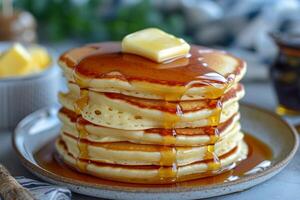 AI generated A fluffy stack of pancakes drizzled with maple syrup, topped with a pat of melting butter. photo