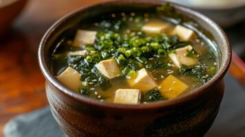 AI generated A classic bowl of miso soup, with tofu and seaweed floating in a savory broth. photo