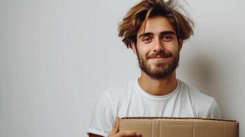 AI generated A young guy, a loader, is carrying a large cardboard box in his hands photo