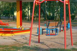 Summer spring children's playground with painted toy slide in park photo