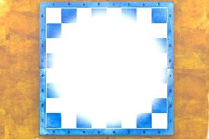 Blue chessboard with white frame on a yellow ocher background, space for text photo