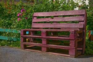 Bench made from wooden boxes on a personal plot in the yard photo