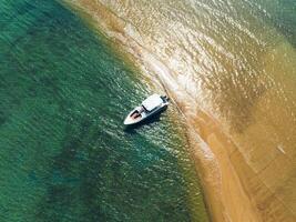 an aerial view of a boat on the beach photo
