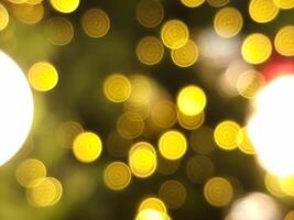 abstract christmas tree bokeh blur light circle red orange and yellow glowing flare pattern black background photo