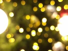 abstract bokeh blur christmas light circle red orange and white glowing flare pattern green background photo