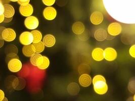 abstract christmas tree bokeh blur light circle red yellow and white glowing flare pattern black background photo