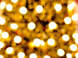 christmas tree abstract bokeh blur light circle red orange and golden glowing flare pattern black background photo