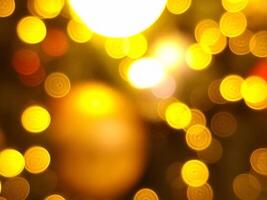 abstract bokeh blur light circle red orange and yellow glowing flare pattern black background for christmas photo