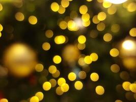 abstract bokeh blur light circle golden orange and yellow  christmas glowing flare pattern black background photo