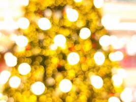 blur light christmas tree abstract bokeh circle red orange and golden glowing flare pattern black background photo