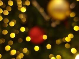 abstract bokeh blur light circle red orange and yellow christmas tree glowing flare pattern black background photo