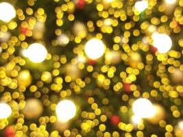 abstract bokeh blur light circle red orange and golden christmas tree glowing flare pattern black background photo