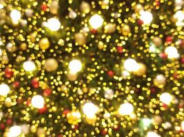 christmas abstract bokeh blur light circle red orange and white glowing flare pattern green background photo