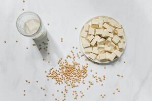 Soybean milk in a glass and soybeans on a white background photo