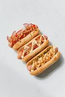 Hot dogs with sausage and ketchup on a white background, top view photo