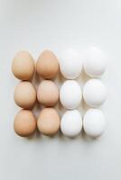 White and brown eggs on a white background. Top view, flat lay photo