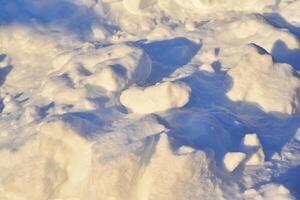 Lumps of snow in winter. Snow and light during the day. Snowdrifts. photo