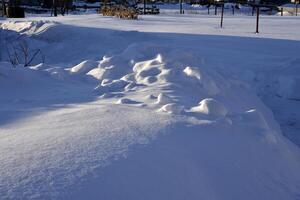 Lumps of snow in winter. Snow and light during the day. Snowdrifts. photo