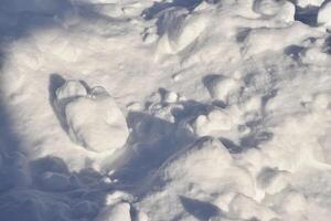 Lumps of snow in winter. Snow and light during the day. Snowdrifts. photo
