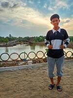 A boy on a mangrove beach in the afternoon photo