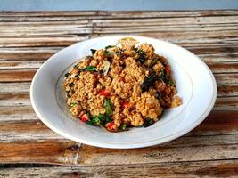 Indonesian cuisine, tempeh kampul with basil leaves photo