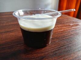 Chocolate pudding and milk in a cup on a wooden table photo