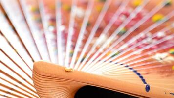 Detail of decorated hand fan in rotation video