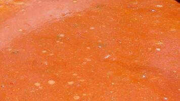 Tomato soup with pasta is a dish of Polish cuisine. Hot Zupa pomidorowa in a large cauldron at the field kitchen at a food fair. A popular soup made from grated tomatoes in their own juice. video