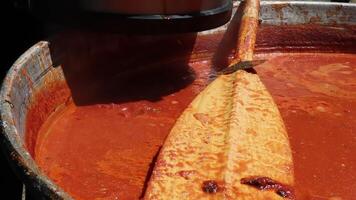 Tomato soup with pasta is a dish of Polish cuisine. Hot Zupa pomidorowa in a large cauldron at the field kitchen at a food fair. A popular soup made from grated tomatoes in their own juice. video