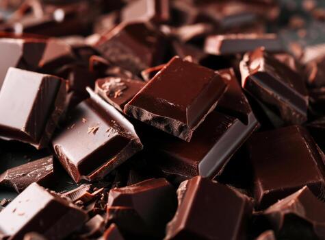 AI generated Pieces of dark chocolate on table closeup Food background photo