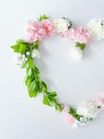 Frame in form of heart from pink, white carnations photo