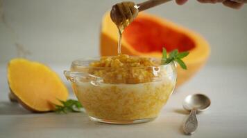 sweet boiled pumpkin porridge in a bowl with honey video