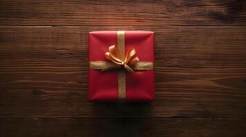 AI generated a red gift box with a gold bow on a wooden surface photo