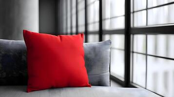 ai generado un rojo almohada sentado en parte superior de un gris sofá foto