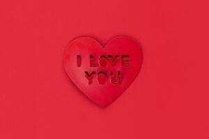 Valentine card shape heart with cut out inscription I love you red photo
