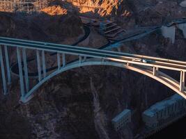 Hoover Dam on the Colorado River straddling Nevada and Arizona at dawn from above. photo