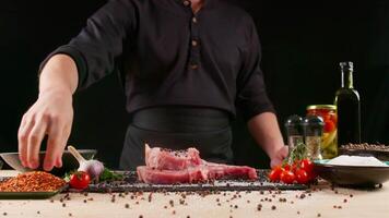 fornello preparazione carne su professionale cucina tavolo con vario verdure 4k filmato. capocuoco epico lancio crudo pezzo di bistecca. video