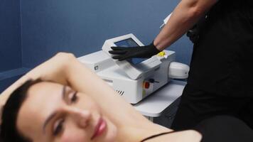 Close up of woman armpit area during procedure of laser hair removal in modern cosmetology clinic. Concept of women beauty, cosmetology, epilation. High quality 4k footage video